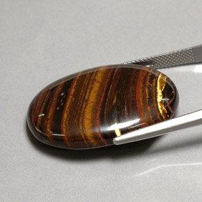Tiger's Eye Matrix طبيعي بلون متعدد الألوان، وزن ‎43.53‎ قيراط، شكل بيضاوى، مقاس ‎31x22.3‎ مم
