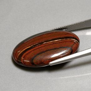 Tiger's Eye Matrix طبيعي بلون متعدد الألوان، وزن ‎35.01‎ قيراط، شكل بيضاوى، مقاس ‎29.9x20‎ مم