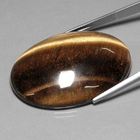 Tiger's Eye طبيعي بلون بني ذهبي، وزن ‎78.03‎ قيراط، شكل بيضاوى، مقاس ‎40.7x30.7‎ مم