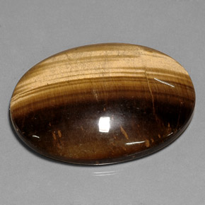 Tiger's Eye طبيعي بلون بني ذهبي، وزن ‎75.05‎ قيراط، شكل بيضاوى، مقاس ‎40.1x30‎ مم