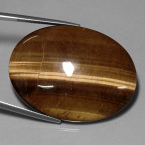Tiger's Eye طبيعي بلون بني ذهبي، وزن ‎75.05‎ قيراط، شكل بيضاوى، مقاس ‎40.1x30‎ مم