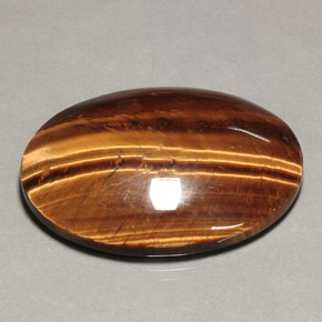 Tiger's Eye طبيعي بلون بني ذهبي، وزن ‎74.22‎ قيراط، شكل بيضاوى، مقاس ‎39.9x30‎ مم