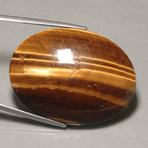 Tiger's Eye طبيعي بلون بني ذهبي، وزن ‎74.22‎ قيراط، شكل بيضاوى، مقاس ‎39.9x30‎ مم