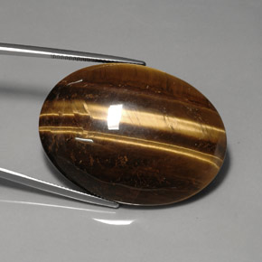 Tiger's Eye طبيعي بلون بني ذهبي، وزن ‎76.92‎ قيراط، شكل بيضاوى، مقاس ‎40x29.9‎ مم