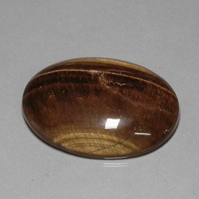 Tiger's Eye طبيعي بلون بني ذهبي، وزن ‎80.28‎ قيراط، شكل بيضاوى، مقاس ‎40x29.9‎ مم