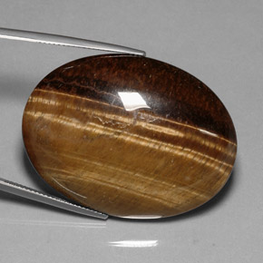 Tiger's Eye طبيعي بلون بني ذهبي، وزن ‎80.28‎ قيراط، شكل بيضاوى، مقاس ‎40x29.9‎ مم