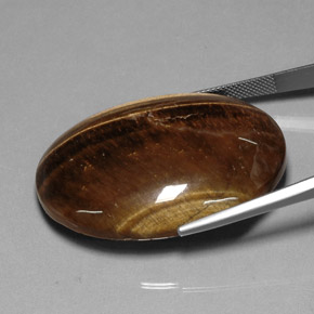 Tiger's Eye طبيعي بلون بني ذهبي، وزن ‎80.28‎ قيراط، شكل بيضاوى، مقاس ‎40x29.9‎ مم