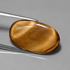 Tiger's Eye طبيعي بلون بني ذهبي، وزن ‎10.07‎ قيراط، شكل بيضاوى، مقاس ‎24.4x14.6‎ مم