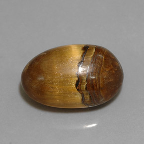 Tiger's Eye طبيعي بلون بني ذهبي، وزن ‎12.90‎ قيراط، شكل بيضاوى، مقاس ‎17.8x11.8‎ مم