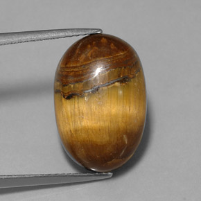 Tiger's Eye طبيعي بلون بني ذهبي، وزن ‎12.90‎ قيراط، شكل بيضاوى، مقاس ‎17.8x11.8‎ مم