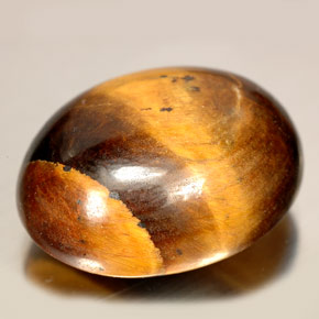 Tiger's Eye طبيعي بلون بني ذهبي، وزن ‎24.55‎ قيراط، شكل بيضاوى، مقاس ‎20.8x16.4‎ مم