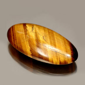 Tiger's Eye طبيعي بلون بني ذهبي، وزن ‎14.67‎ قيراط، شكل بيضاوى، مقاس ‎24.8x12.3‎ مم