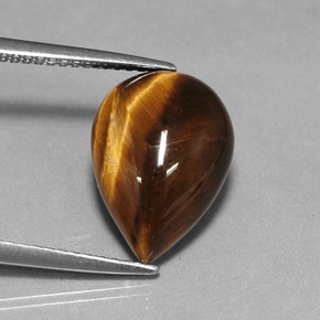 Tiger's Eye طبيعي بلون بني ذهبي، وزن ‎5.02‎ قيراط، شكل شكل الكمثرى، مقاس ‎14x10.1‎ مم