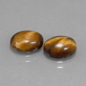 Tiger's Eye طبيعي بلون بني ذهبي، وزن ‎1.59‎ قيراط، شكل بيضاوى، مقاس ‎8.7x6.8‎ مم