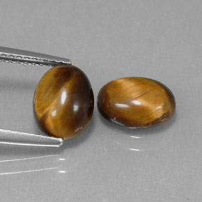 Tiger's Eye طبيعي بلون بني ذهبي، وزن ‎1.59‎ قيراط، شكل بيضاوى، مقاس ‎8.7x6.8‎ مم