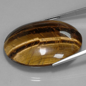 Tiger's Eye طبيعي بلون بني ذهبي، وزن ‎73.05‎ قيراط، شكل بيضاوى، مقاس ‎39.8x24.1‎ مم