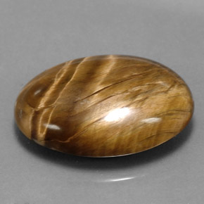 Tiger's Eye طبيعي بلون بني ذهبي، وزن ‎17.34‎ قيراط، شكل بيضاوى، مقاس ‎22.6x15.6‎ مم