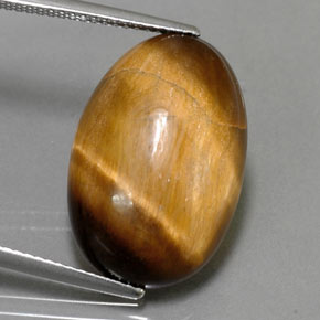 Tiger's Eye طبيعي بلون بني ذهبي، وزن ‎13.32‎ قيراط، شكل بيضاوى، مقاس ‎20.8x13.8‎ مم