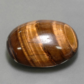 Tiger's Eye طبيعي بلون بني ذهبي، وزن ‎24.80‎ قيراط، شكل بيضاوى، مقاس ‎21.7x16.8‎ مم