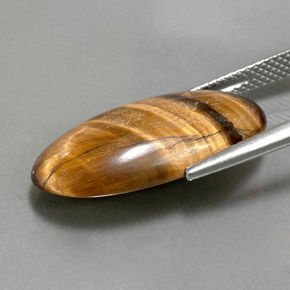 Tiger's Eye طبيعي بلون بني ذهبي، وزن ‎11.79‎ قيراط، شكل بيضاوى، مقاس ‎23.3x12.2‎ مم