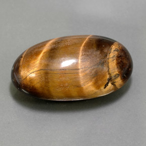 Tiger's Eye طبيعي بلون بني ذهبي، وزن ‎26.13‎ قيراط، شكل بيضاوى، مقاس ‎24.8x15.3‎ مم