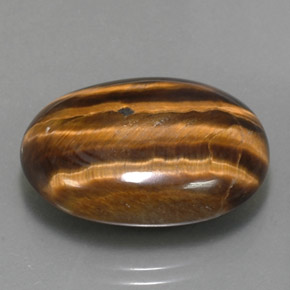 Tiger's Eye طبيعي بلون بني ذهبي، وزن ‎25.04‎ قيراط، شكل بيضاوى، مقاس ‎23.9x18‎ مم