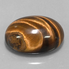 Tiger's Eye طبيعي بلون بني ذهبي، وزن ‎15.36‎ قيراط، شكل بيضاوى، مقاس ‎18.9x14‎ مم