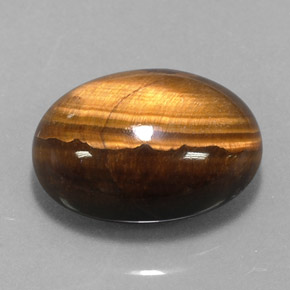 Tiger's Eye طبيعي بلون بني ذهبي، وزن ‎12.49‎ قيراط، شكل بيضاوى، مقاس ‎17x13.3‎ مم