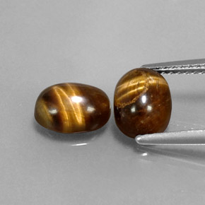 Tiger's Eye طبيعي بلون بني ذهبي، وزن ‎‎ قيراط، شكل بيضاوى، مقاس ‎8.1x6.2‎ مم