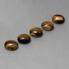 Tiger's Eye طبيعي بلون بنى متوسط، وزن ‎10.03‎ قيراط، شكل بيضاوى، مقاس ‎9x7‎ مم