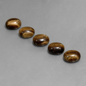 Tiger's Eye طبيعي بلون بنى متوسط، وزن ‎10.03‎ قيراط، شكل بيضاوى، مقاس ‎9x7‎ مم