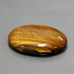 Tiger's Eye طبيعي بلون بني ذهبي، وزن ‎68.47‎ قيراط، شكل بيضاوى، مقاس ‎39.2x27.1‎ مم