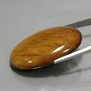 Tiger's Eye طبيعي بلون بني ذهبي، وزن ‎68.47‎ قيراط، شكل بيضاوى، مقاس ‎39.2x27.1‎ مم