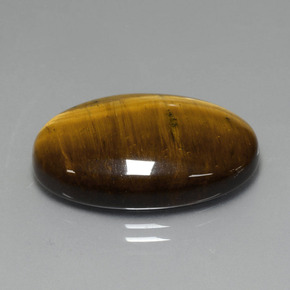 Tiger's Eye طبيعي بلون بنى فاتح-متوسط، وزن ‎19.40‎ قيراط، شكل بيضاوى، مقاس ‎24.7x16.6‎ مم