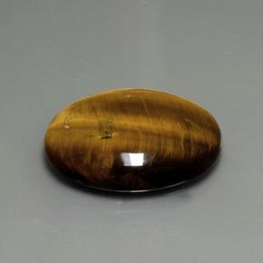 Tiger's Eye طبيعي بلون بني ذهبي، وزن ‎22.43‎ قيراط، شكل بيضاوى، مقاس ‎25.2x20.3‎ مم