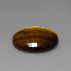 Tiger's Eye طبيعي بلون بني ذهبي، وزن ‎22.74‎ قيراط، شكل بيضاوى، مقاس ‎25.3x20.2‎ مم