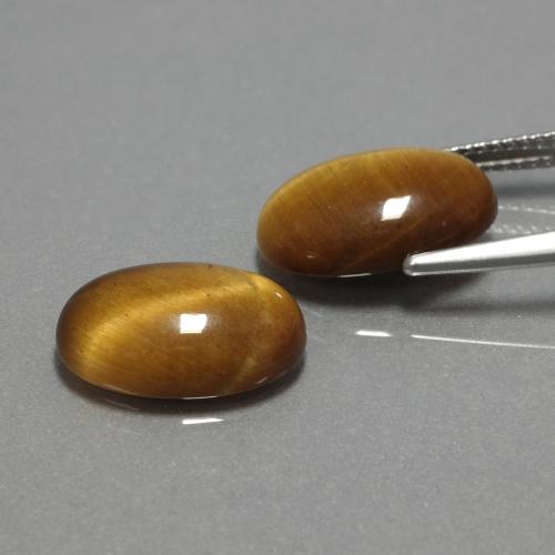 Tiger's Eye طبيعي بلون بني ذهبي، وزن ‎9.04‎ قيراط، شكل بيضاوى، مقاس ‎14x10‎ مم