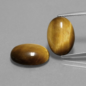 Tiger's Eye طبيعي بلون بنى فاتح-متوسط، وزن ‎9.10‎ قيراط، شكل بيضاوى، مقاس ‎14.1x10‎ مم