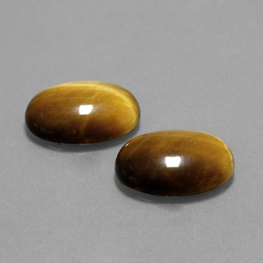 Tiger's Eye طبيعي بلون بنى فاتح-متوسط، وزن ‎9.10‎ قيراط، شكل بيضاوى، مقاس ‎14.1x10‎ مم