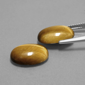 Tiger's Eye طبيعي بلون بنى فاتح-متوسط، وزن ‎9.10‎ قيراط، شكل بيضاوى، مقاس ‎14.1x10‎ مم