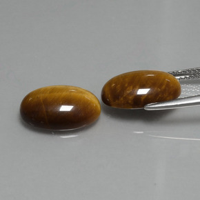 Tiger's Eye طبيعي بلون بنى دافئ، وزن ‎9.08‎ قيراط، شكل بيضاوى، مقاس ‎14x10‎ مم