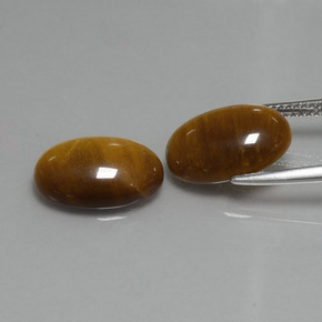 Tiger's Eye طبيعي بلون بنى متوسط، وزن ‎9.04‎ قيراط، شكل بيضاوى، مقاس ‎14x10‎ مم