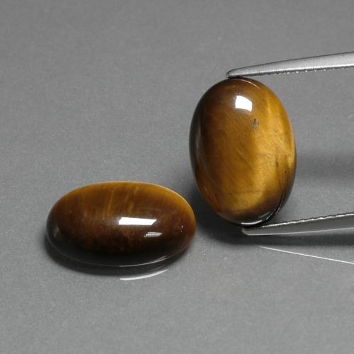 أحجار عين النمر بني ذهبي طبيعية، قصة بيضاوى، غير شفاف، وزنها 9.11 قيراط