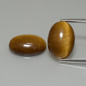 Tiger's Eye طبيعي بلون بنى فاتح-متوسط، وزن ‎9.19‎ قيراط، شكل بيضاوى، مقاس ‎14x10‎ مم
