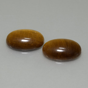 Tiger's Eye طبيعي بلون بنى فاتح-متوسط، وزن ‎9.19‎ قيراط، شكل بيضاوى، مقاس ‎14x10‎ مم