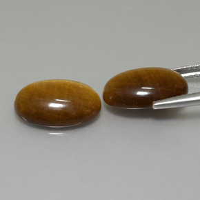 Tiger's Eye طبيعي بلون بنى فاتح-متوسط، وزن ‎9.19‎ قيراط، شكل بيضاوى، مقاس ‎14x10‎ مم