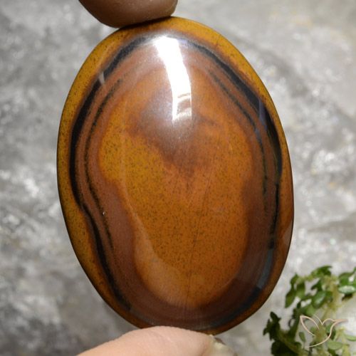 Tiger's Eye طبيعي بلون بنى دافئ، وزن ‎92.65‎ قيراط، شكل بيضاوى، مقاس ‎40.8x29.4‎ مم