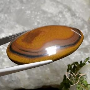 Tiger's Eye طبيعي بلون بنى دافئ، وزن ‎92.65‎ قيراط، شكل بيضاوى، مقاس ‎40.8x29.4‎ مم