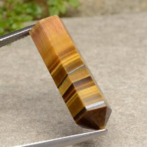 Tiger's Eye طبيعي بلون بني ذهبي، وزن ‎18.73‎ قيراط، شكل شكل خيالي، مقاس ‎28.8x9.2‎ مم
