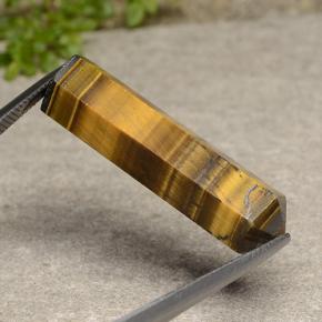 Tiger's Eye طبيعي بلون بني فاتح، وزن ‎24.72‎ قيراط، شكل شكل خيالي، مقاس ‎33.1x9.5‎ مم